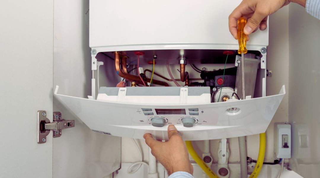 Boiler Servicing (3) Boiler with cover off and engineer working on it